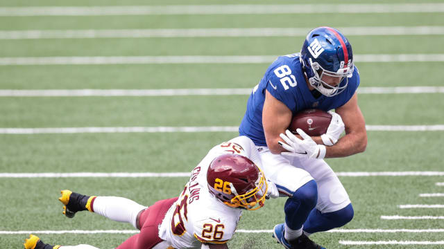 Oct 18, 2020; East Rutherford, New Jersey, USA; New York Giants tight end Kaden Smith (82) is tackled by Washington Football Team safety Landon Collins (26) during the first half at MetLife Stadium. Mandatory Credit: Vincent Carchietta-USA TODAY Sports